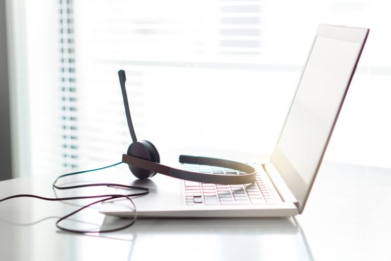 headset sitting on top of open laptop